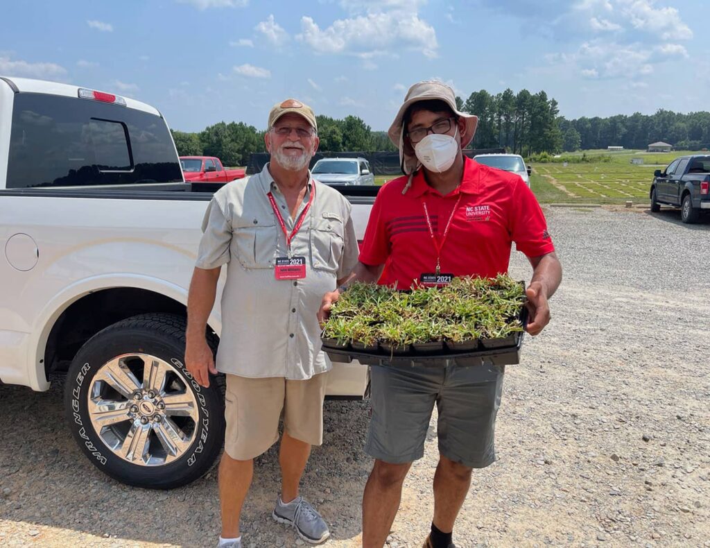 John Williams checking out turfgrass samples with Esdras Carbajal, a turfgrass research specialist at NC State.