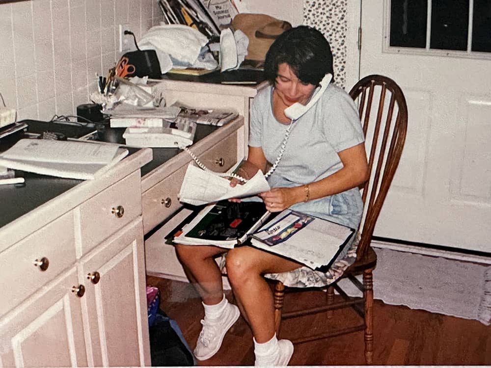 Lee Ann Wagner on the phone at the desk in their kitchen during the early days of running the business.